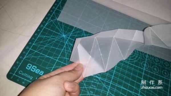 Illustration of the manual origami process of a simplified hexagonal box